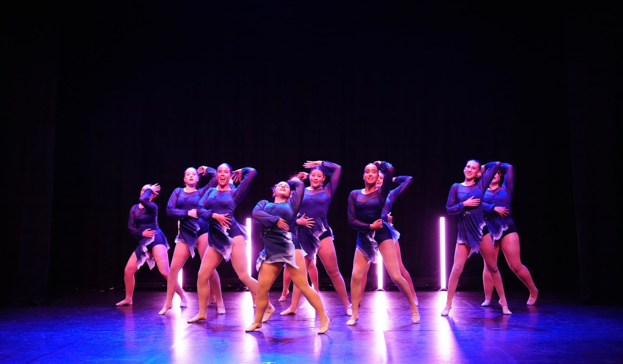 Senior lyrical group under purple neon bars