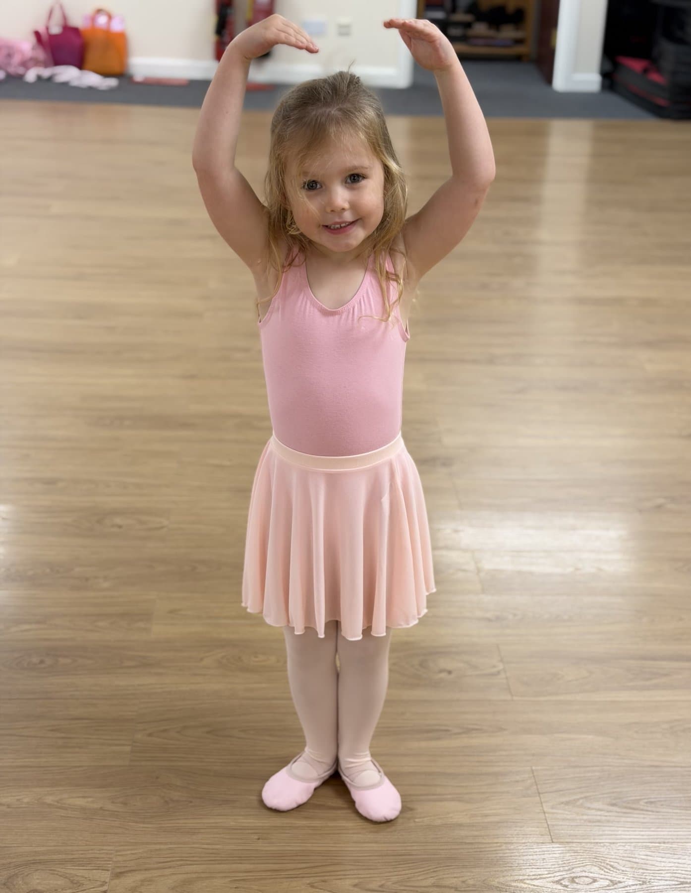 Young Ballet Totz student smiling in a pink leotard and tutu